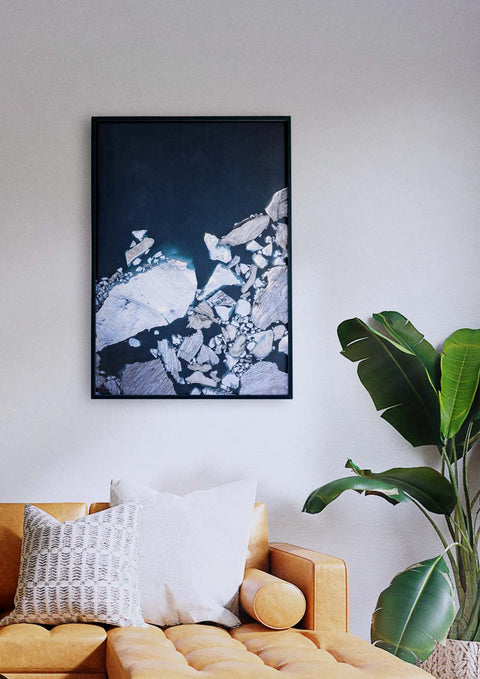 Eine Couch im Wohnzimmer mit einem Eisberge-Bild darüber.