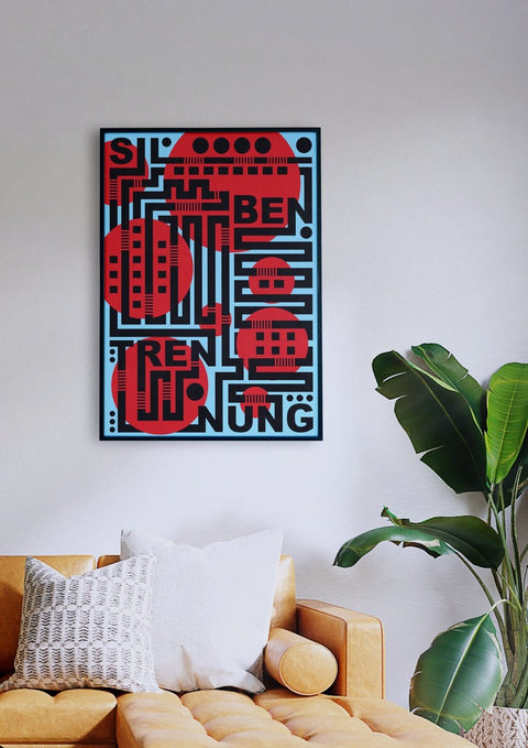 Ein Wohnzimmer mit einer Couch und einer Silbertrennung, dekoriert mit einem typografischen Poster in kontrastreichen Farben.