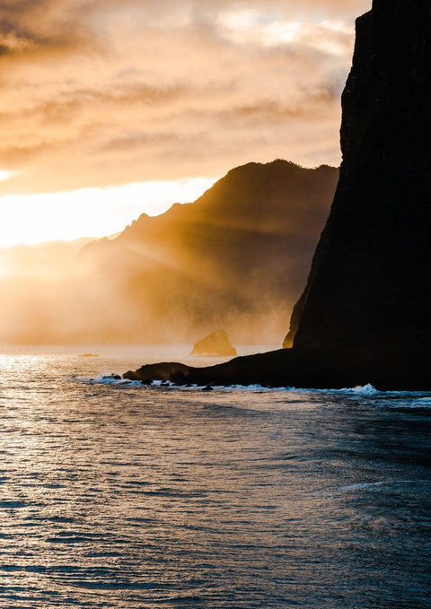 Eine Fotografie von Tranquility über dem Ozean mit einer Klippe im Hintergrund.